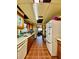 Long kitchen featuring wood cabinets, tile floors, and appliances at 6265 Viola Ln, New Port Richey, FL 34653
