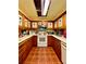 U-shaped kitchen with warm wooden cabinets and red flower stained glass at 6265 Viola Ln, New Port Richey, FL 34653