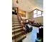 Bright living room with a staircase, high ceilings, a sofa, and a large window at 6265 Viola Ln, New Port Richey, FL 34653