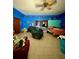 Spacious living room with a recliner chair, a tv, and a bed with blue walls at 6265 Viola Ln, New Port Richey, FL 34653