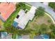 Aerial view of the property featuring a pool, lush landscaping, and surrounding neighborhood at 6470 Indigo Bunting Pl, Lakewood Ranch, FL 34202