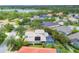 Expansive aerial shot of homes with pools and lake views, surrounded by lush greenery at 6470 Indigo Bunting Pl, Lakewood Ranch, FL 34202