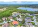 Panoramic aerial view of a residential area adjacent to a serene lake and green spaces at 6470 Indigo Bunting Pl, Lakewood Ranch, FL 34202