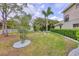 Large backyard with lush landscaping, white picket fence, and manicured lawn at 6470 Indigo Bunting Pl, Lakewood Ranch, FL 34202