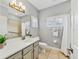 Traditional bathroom featuring a single sink with tiled floors, a large mirror, and a shower at 6470 Indigo Bunting Pl, Lakewood Ranch, FL 34202