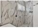 Contemporary shower with marble tiling, a rainfall showerhead, and a bench at 6470 Indigo Bunting Pl, Lakewood Ranch, FL 34202