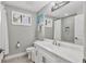 Well-lit bathroom with white vanity, neutral walls, and a shower at 6470 Indigo Bunting Pl, Lakewood Ranch, FL 34202