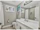 Bright bathroom features dual windows, walk-in shower, and white vanity with modern fixtures at 6470 Indigo Bunting Pl, Lakewood Ranch, FL 34202