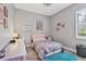Cozy bedroom featuring hardwood floors, neutral walls, and modern desk at 6470 Indigo Bunting Pl, Lakewood Ranch, FL 34202