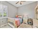 Cozy bedroom featuring light hardwood floors, neutral walls, and plush rug at 6470 Indigo Bunting Pl, Lakewood Ranch, FL 34202