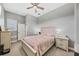 Bright bedroom features a ceiling fan, neutral walls, light wood furnishings, and carpet flooring at 6470 Indigo Bunting Pl, Lakewood Ranch, FL 34202