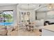 Bright dining area with white shutters, a round table, and views of the pool and landscaped yard at 6470 Indigo Bunting Pl, Lakewood Ranch, FL 34202