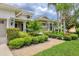 Beautifully landscaped front yard with lush greenery and a brick walkway leading to the home at 6470 Indigo Bunting Pl, Lakewood Ranch, FL 34202