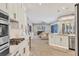 Contemporary kitchen flowing into the living area, featuring modern appliances and finishes at 6470 Indigo Bunting Pl, Lakewood Ranch, FL 34202