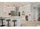 Modern kitchen with white cabinets, a large island, stainless steel appliances, and stylish pendant lighting at 6470 Indigo Bunting Pl, Lakewood Ranch, FL 34202