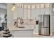 Stylish kitchen featuring white cabinets, pendant lighting, and stainless steel appliances at 6470 Indigo Bunting Pl, Lakewood Ranch, FL 34202