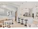 Elegant kitchen with white cabinets, stainless steel appliances, and pendant lighting over a quartz countertop island at 6470 Indigo Bunting Pl, Lakewood Ranch, FL 34202