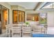Relaxing screened-in lanai with dining set, overlooking the pool and lush backyard at 6470 Indigo Bunting Pl, Lakewood Ranch, FL 34202