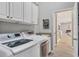 Well-equipped laundry room boasts modern washer and dryer at 6470 Indigo Bunting Pl, Lakewood Ranch, FL 34202