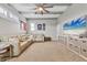 Large living room featuring ceiling fan, beamed ceilings, sectional couch and entertainment center at 6470 Indigo Bunting Pl, Lakewood Ranch, FL 34202