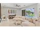 Comfortable living room with a large sectional sofa, decorative fireplace, and sliding glass doors to the pool area at 6470 Indigo Bunting Pl, Lakewood Ranch, FL 34202