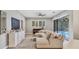 Comfortable living room with a large sectional sofa, decorative fireplace, and sliding glass doors to the pool area at 6470 Indigo Bunting Pl, Lakewood Ranch, FL 34202