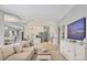 Spacious living room flowing into a bright, open kitchen with modern appliances and lots of cabinet space at 6470 Indigo Bunting Pl, Lakewood Ranch, FL 34202