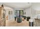 Open living room area with four chairs and view to the patio at 6470 Indigo Bunting Pl, Lakewood Ranch, FL 34202