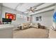 Spacious living room with beamed ceilings, fan, and comfortable sectional couch at 6470 Indigo Bunting Pl, Lakewood Ranch, FL 34202