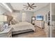 Serene main bedroom with neutral colors, a ceiling fan, and an ensuite bathroom at 6470 Indigo Bunting Pl, Lakewood Ranch, FL 34202