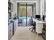 Well-lit office with sleek furniture, built-in cabinets, and a view of the outdoor pool area at 6470 Indigo Bunting Pl, Lakewood Ranch, FL 34202