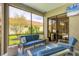 Relax on the screened-in patio with comfortable seating and a view of the landscaped yard at 6470 Indigo Bunting Pl, Lakewood Ranch, FL 34202