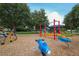 A playground with colorful play structures, seesaw toys and trees at 6470 Indigo Bunting Pl, Lakewood Ranch, FL 34202
