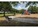 Playground in park setting features benches, walking path, and various play structures for children at 6470 Indigo Bunting Pl, Lakewood Ranch, FL 34202