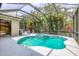 Inviting screened-in pool and spa surrounded by lush landscaping and mature trees at 6470 Indigo Bunting Pl, Lakewood Ranch, FL 34202