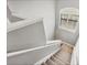 Carpeted staircase features white banister and window with great light at 6470 Indigo Bunting Pl, Lakewood Ranch, FL 34202