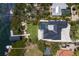 Stunning waterfront property featuring a private dock, lush landscaping, and a sparkling pool at 705 89Th Nw Ct, Bradenton, FL 34209
