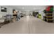 Finished basement featuring speckled flooring, large shelving units and a rear exit at 705 89Th Nw Ct, Bradenton, FL 34209