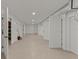Bright basement featuring tan epoxy floors, white walls, and multiple white doors at 705 89Th Nw Ct, Bradenton, FL 34209