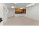 Unfinished basement area featuring tan epoxy floors, a utility cabinet and door at 705 89Th Nw Ct, Bradenton, FL 34209