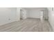 A modern basement featuring light-colored wood-look floors and white trim and neutral paint at 705 89Th Nw Ct, Bradenton, FL 34209