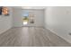 Open basement area with vinyl wood-look floors and glass doors accessing the yard at 705 89Th Nw Ct, Bradenton, FL 34209