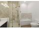 Elegant bathroom features a glass enclosed shower, soaking tub, and modern fixtures at 705 89Th Nw Ct, Bradenton, FL 34209