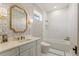 Bright bathroom with marble wall tile, unique wallpaper, and gold fixtures at 705 89Th Nw Ct, Bradenton, FL 34209