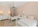 Charming bedroom with twin beds, chandelier lighting, and ample closet space at 705 89Th Nw Ct, Bradenton, FL 34209