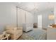 Well-appointed Bedroom with crib, plush chair, stylish rug, and elegant chandelier lighting at 705 89Th Nw Ct, Bradenton, FL 34209