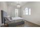 Inviting bedroom featuring a comfortable bed, chandelier, and well-lit arched windows at 705 89Th Nw Ct, Bradenton, FL 34209