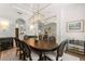 Stylish dining area with a large table, elegant chandelier, and views of the adjacent living spaces for seamless entertaining at 705 89Th Nw Ct, Bradenton, FL 34209