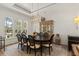 Elegant dining room with a large table, chandelier, and plenty of natural light for memorable gatherings at 705 89Th Nw Ct, Bradenton, FL 34209