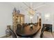 Dining space with stylish chandelier and china cabinet, perfect for displaying cherished dishware and décor at 705 89Th Nw Ct, Bradenton, FL 34209